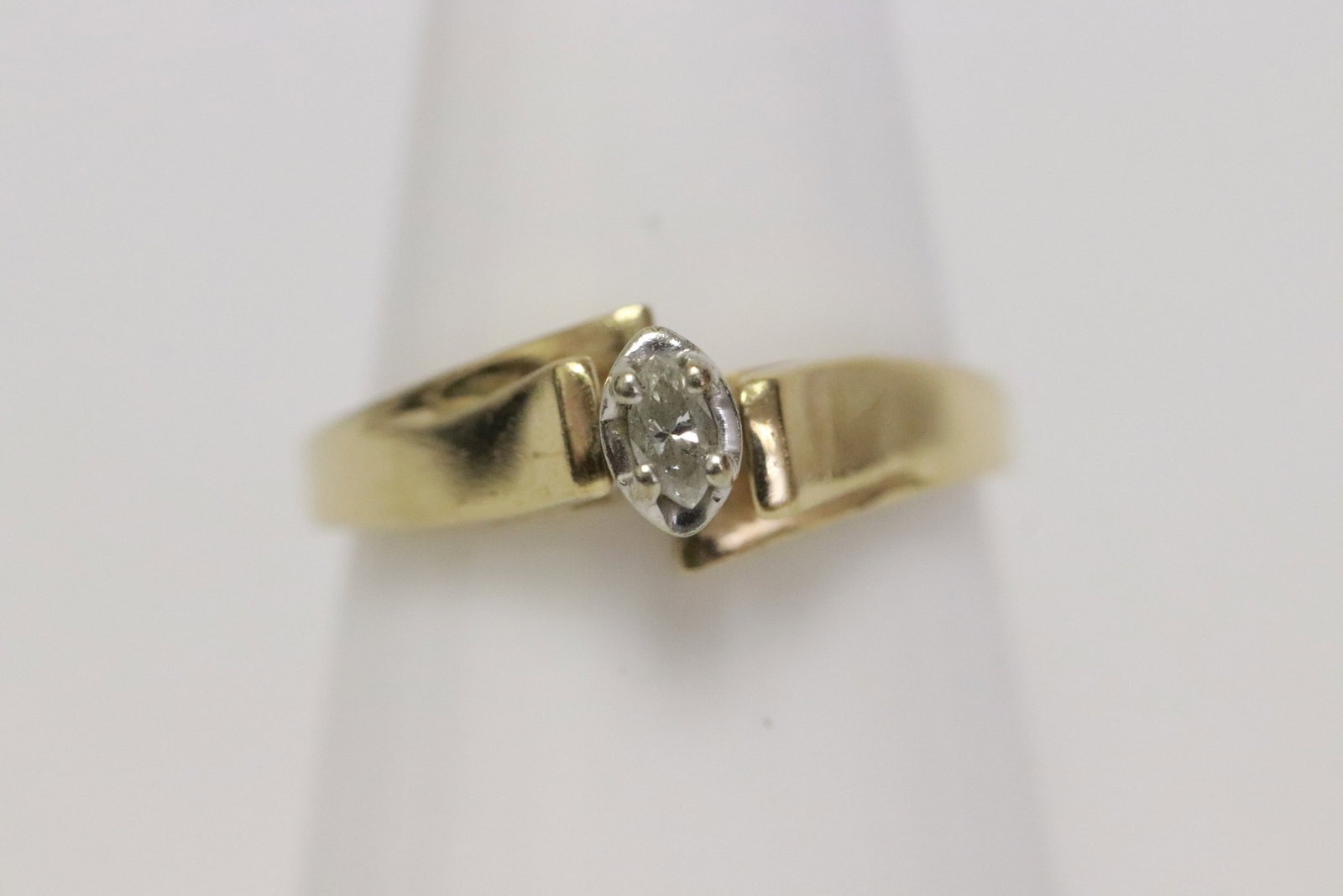 A 10K Y/G diamond ring: A 10K Y/G ring, center a marquise shape diamond wt. approx. 0.10ct, wt. 2.5gm
