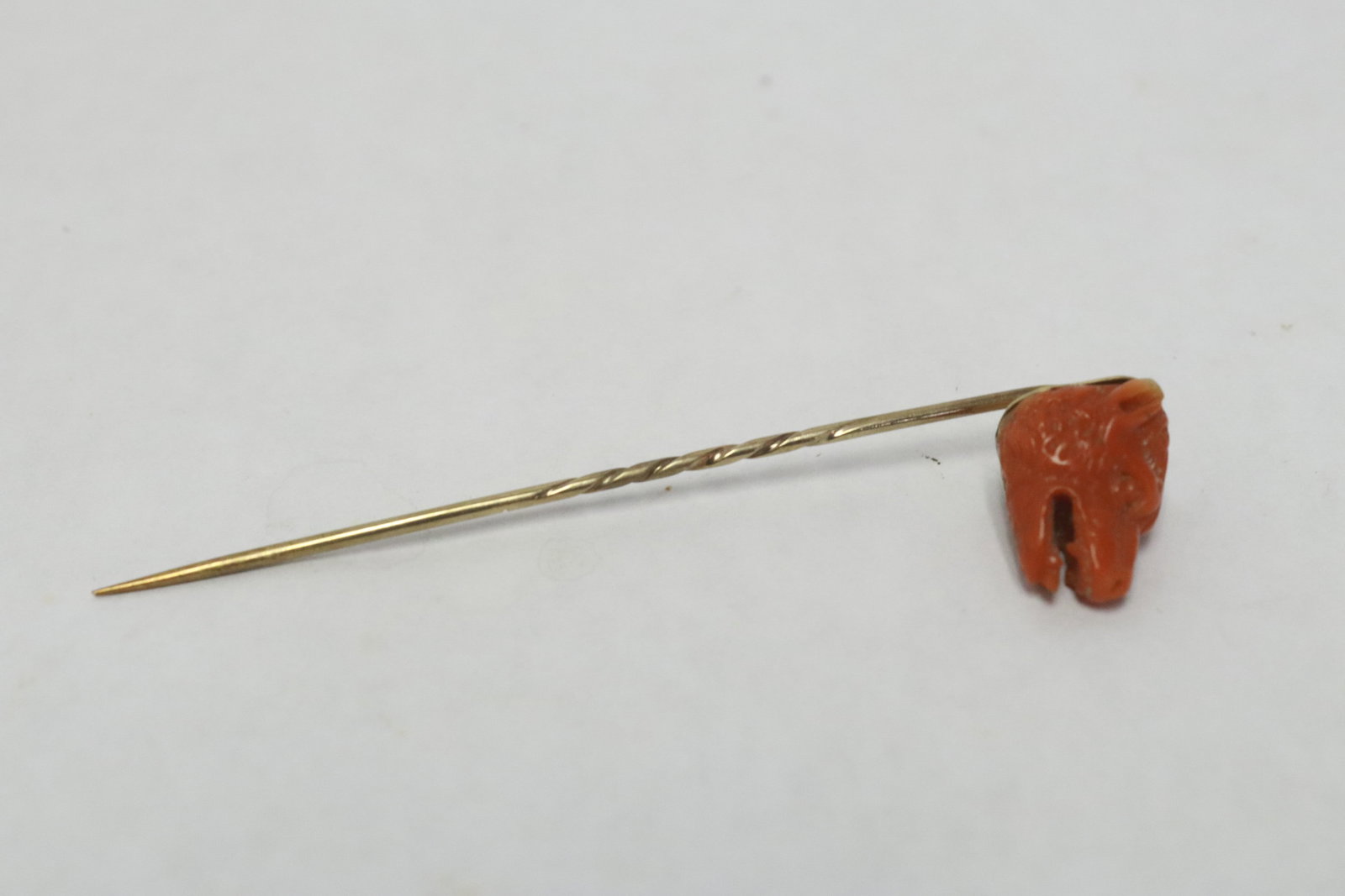 Victorian 9K Y/G stick pin w/ carved coral: Victorian 9K Y/G stick pin (3.18'L) with finely carved coral (0.6"x0.5"x0.65") in boar head motif, wt. 4.7gm, NO INTERNATIONALSHIPPING OF CORAL