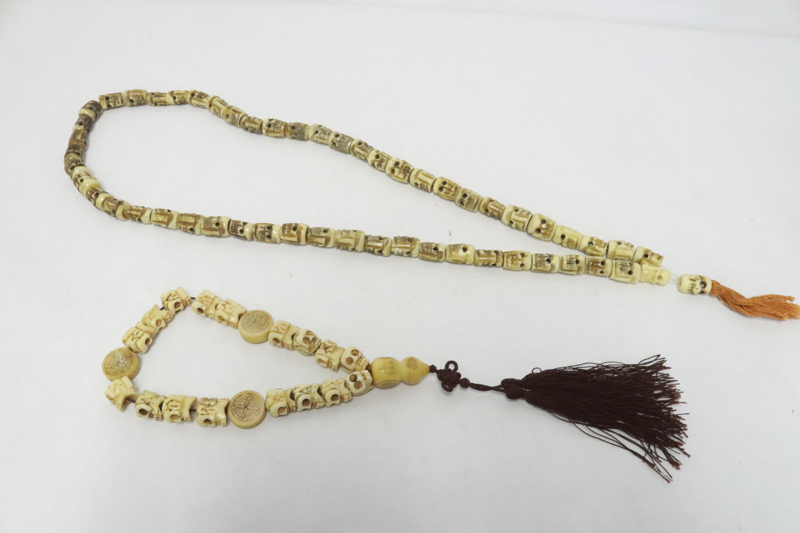 A bone carved link necklace, and bracelet set: A bone carved link necklace (31.4"L), and bracelet (~10.5"L) set, both with skull motif links