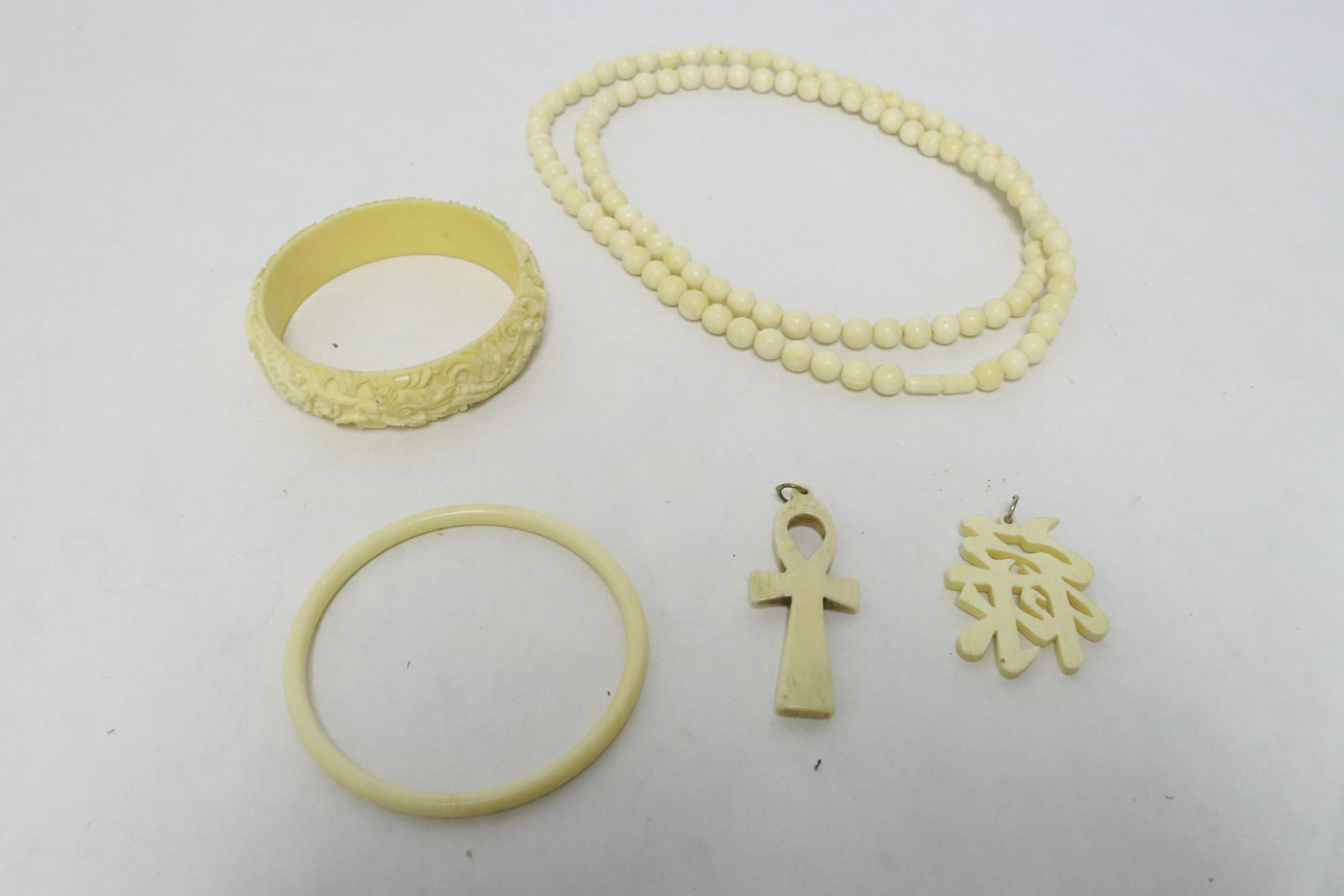 5 pieces bone carved jewelry; 2 bangles, one necklace, and 2 pendants (1 of 8)