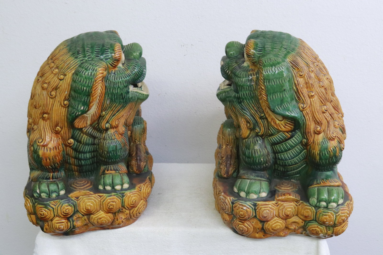 Pair Chinese massive sancai earthenware fulions: Pair Chinese massive sancai earthenware fulions, small chips, 16.2"H ea