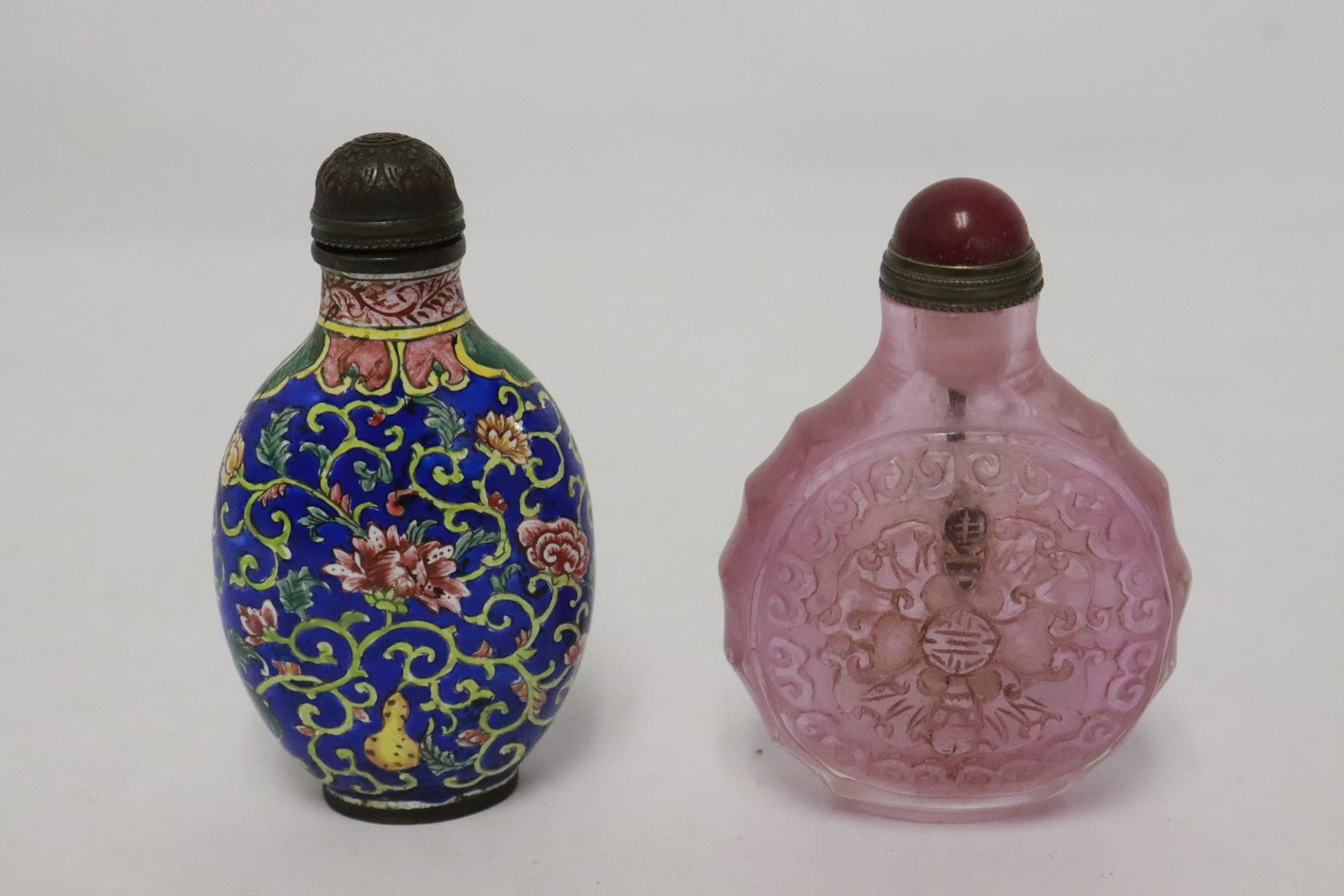 2 snuff bottles: 2 snuff bottles; one Peking glass (2.8"x2"x1.1"), one enamel on metal (2.9"x1.65"x1")