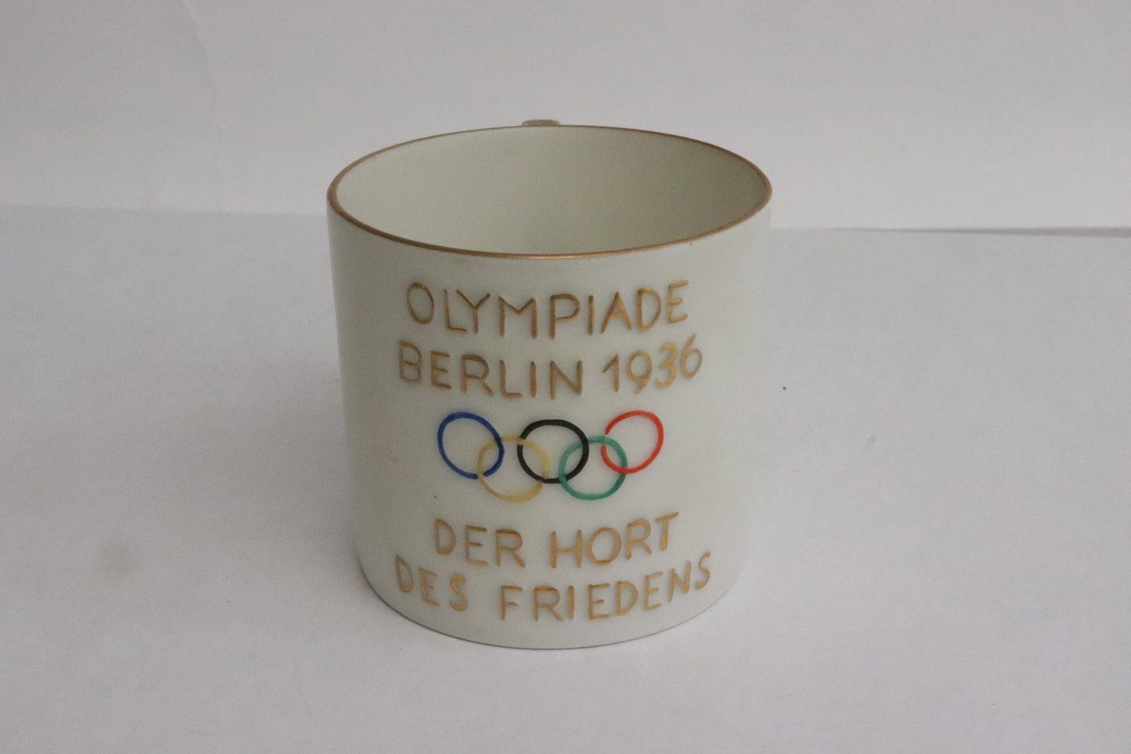 1936 Berlin Olympic memorabilia porcelain cup: A German 1936 Berlin Olympic memorabilia porcelain cup, crack, 2.3"x3.35"x2.5"