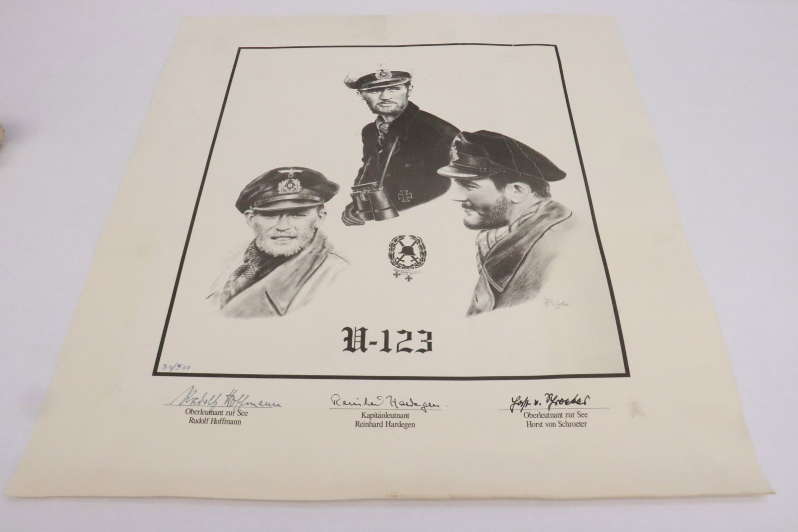 A limited edition print, hand signed on bottom: A limited edition print (30/500) depicting WWII U-123 officers, hand signed on bottom, repair, 19.4"x17.4"