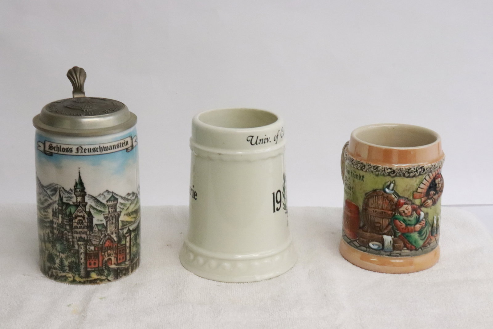 3 beer steins; including a dated 1937 UCLA example: 3 beer steins (4.8"x5.3"x3.9"- 6.85"x5.5"x3.8"); including a dated 1937 UCLA example