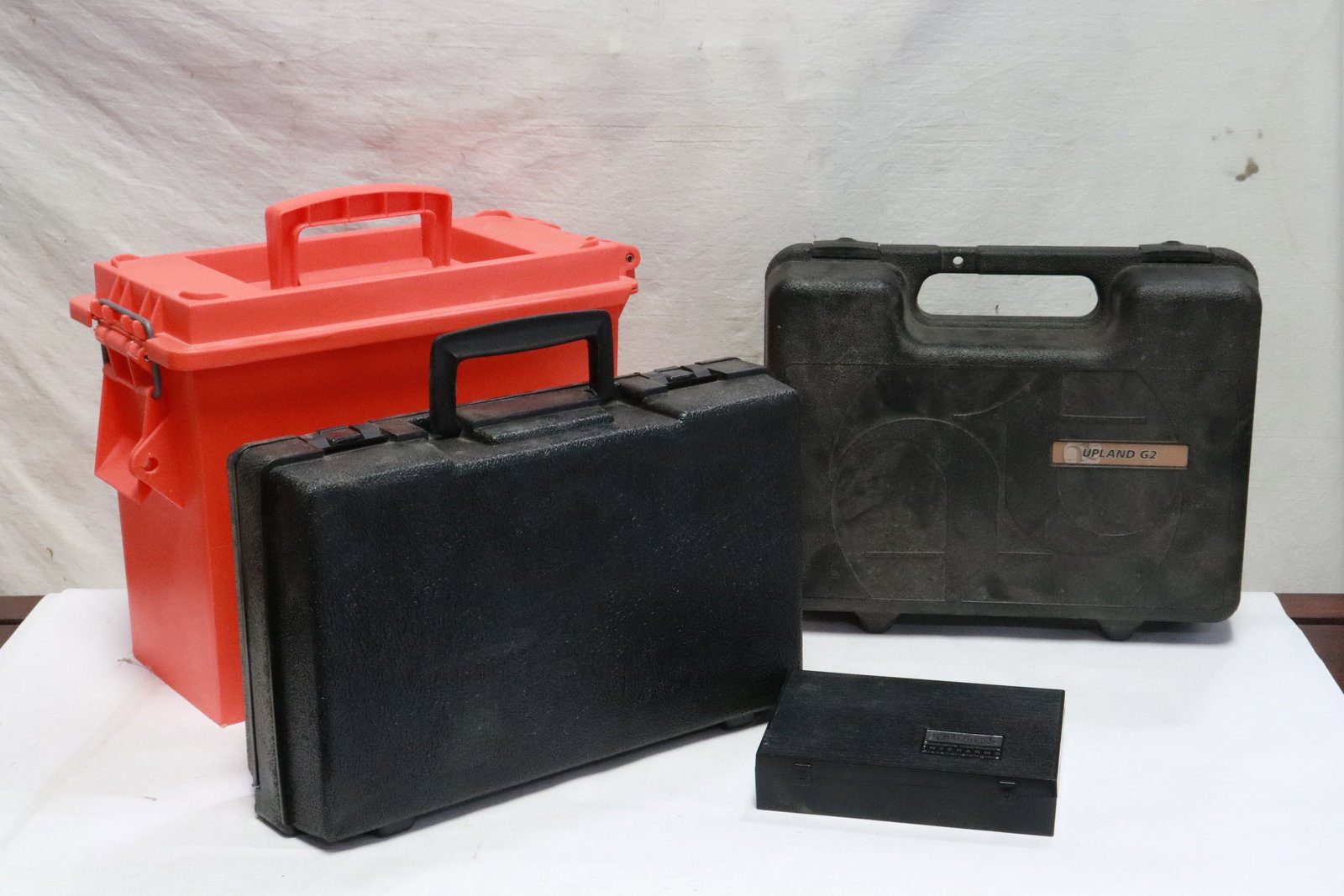 4 hard plastic cases: 2 hard plastic pistol cases (11.3"x13.5"x4.5" ea), a hard plastic storage case (11.4"x15.2"x7.8"), and a hard plastic bullet case (5.3"x6.9"x1.4")