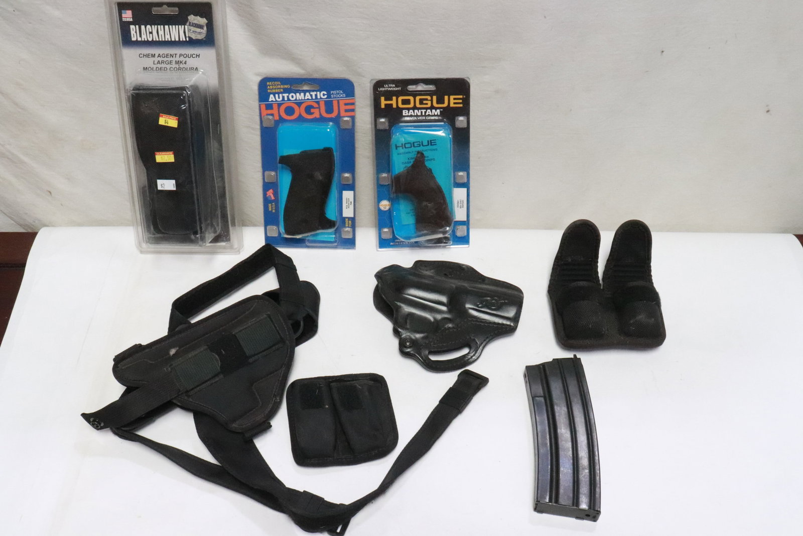 8 items: 2 pistol holsters, 2 pairs pistol grips, 3 bullet pouches, and a magazine