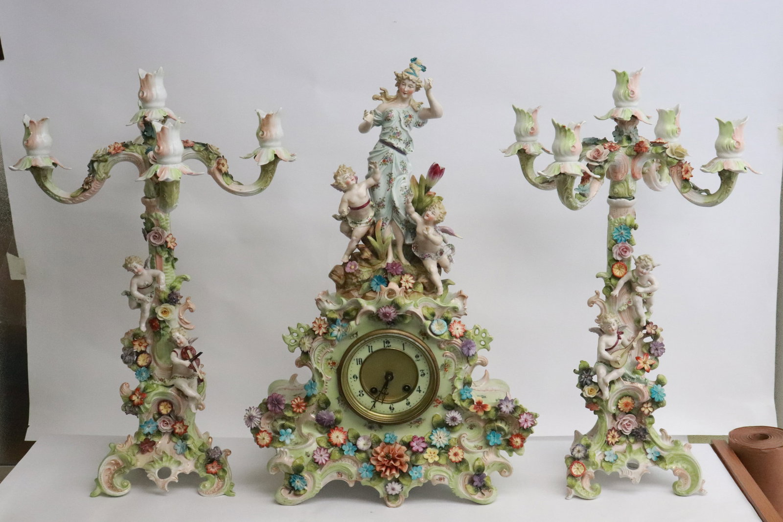 3 pieces French clock candelabra set: Beautiful 3 pieces French clock (21"x14"x6.5") candelabra (20.5"H ea) set decorated with goddess and angels, a fine example, minor chips, repair