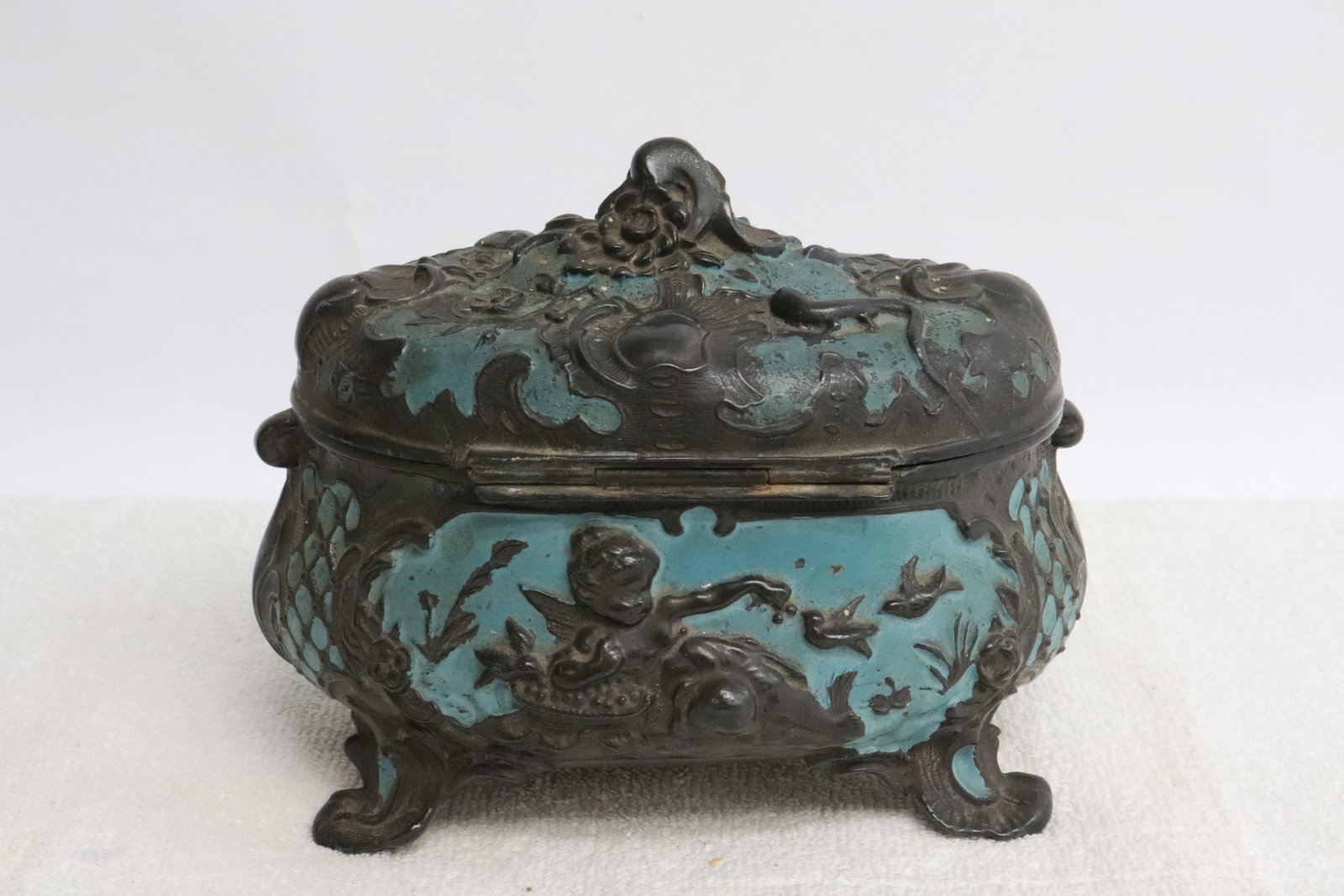 Antique French jewelry box: Antique French jewelry box with angel motif decoration in relief, one leg has repair, 4.9"x6.2"x4.4"