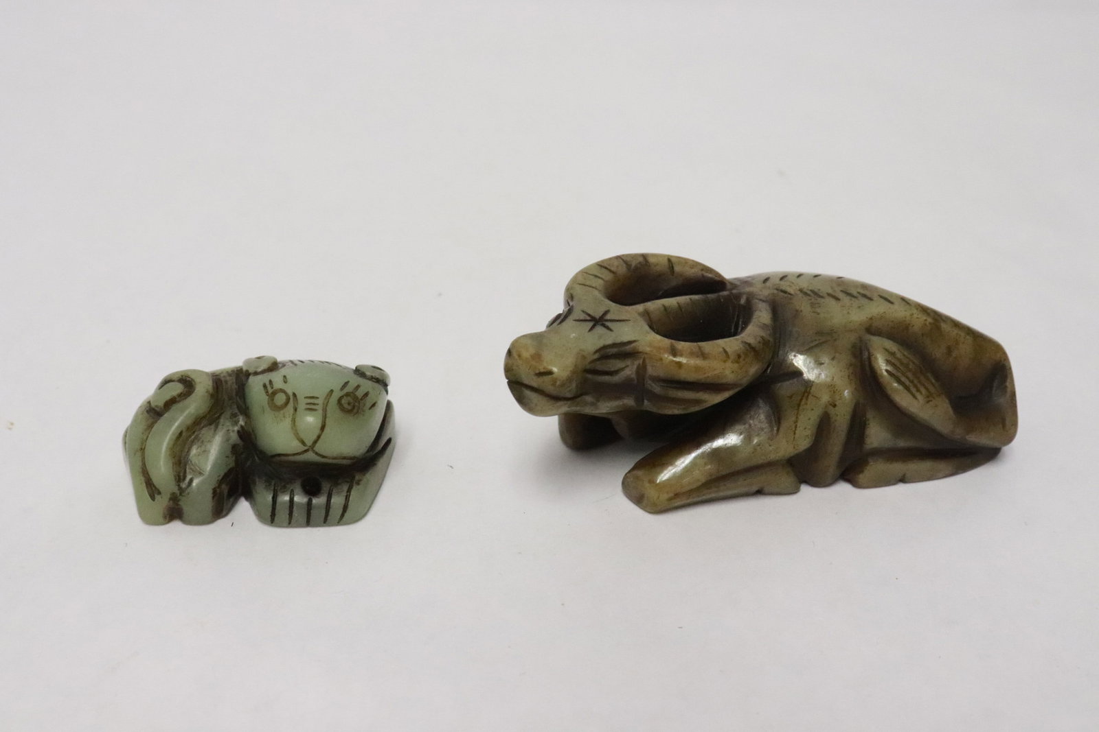 2 jade carvings; a water buffalo, and a tiger: 2 jade carvings; a water buffalo (1.4"x3.85"x1.65"), and a tiger (1"x2"x1.35")