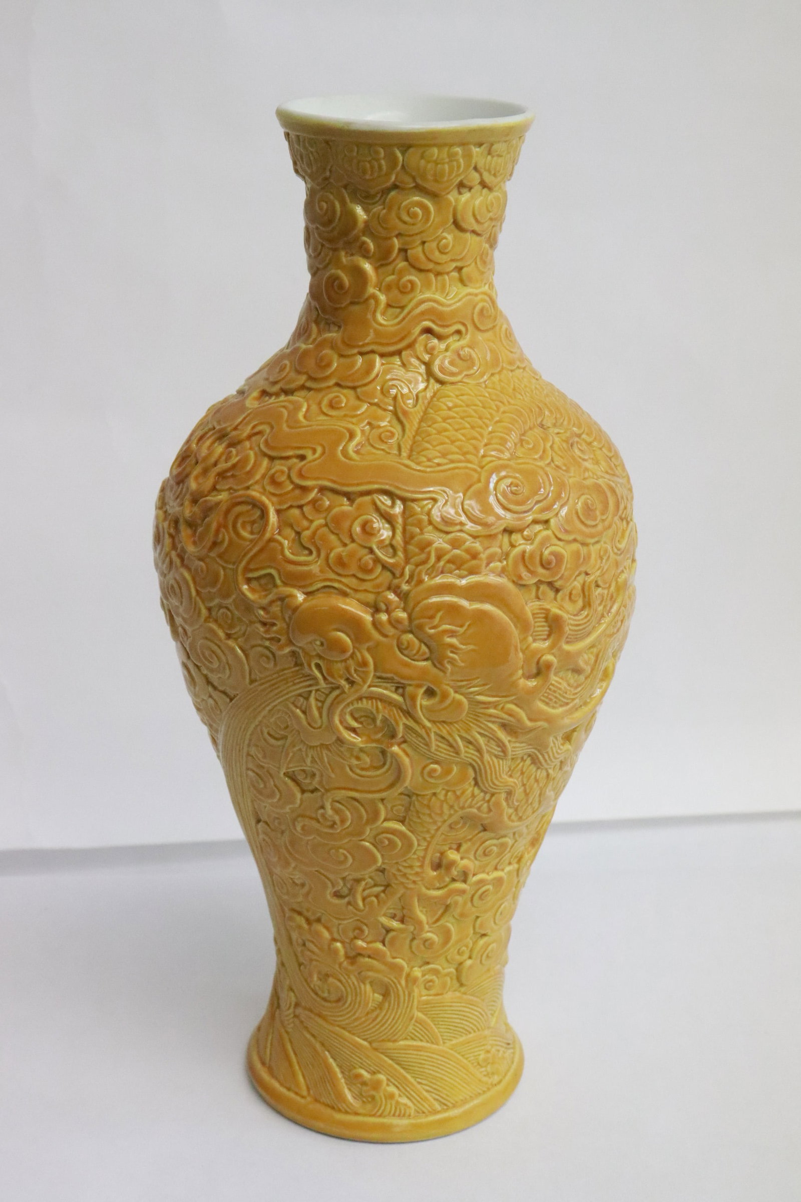 A yellow glazed and carved porcelain vase (1 of 8)