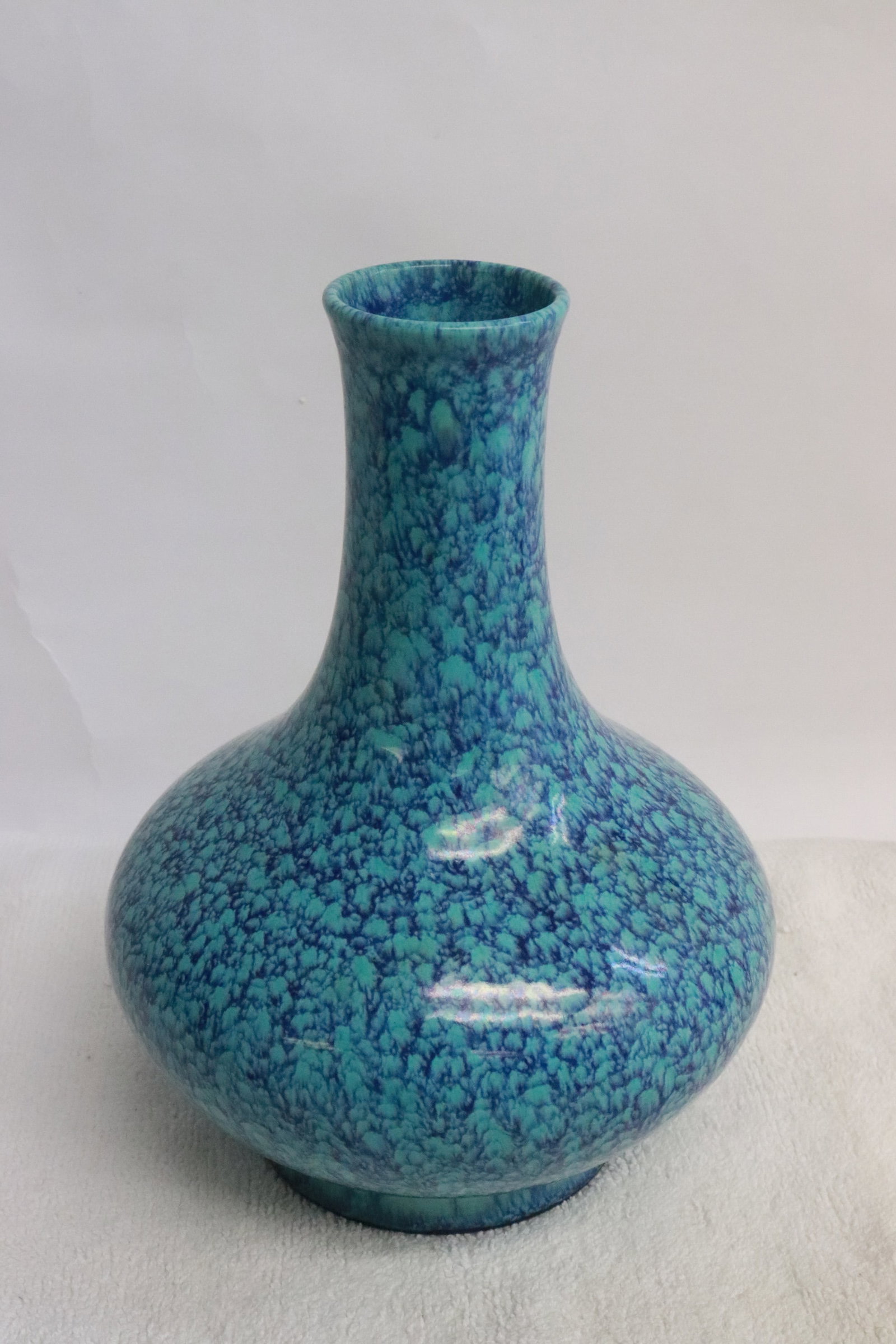 A blue on blue porcelain bottle vase: A blue on blue porcelain bottle vase, 7.25"x5.4"dia