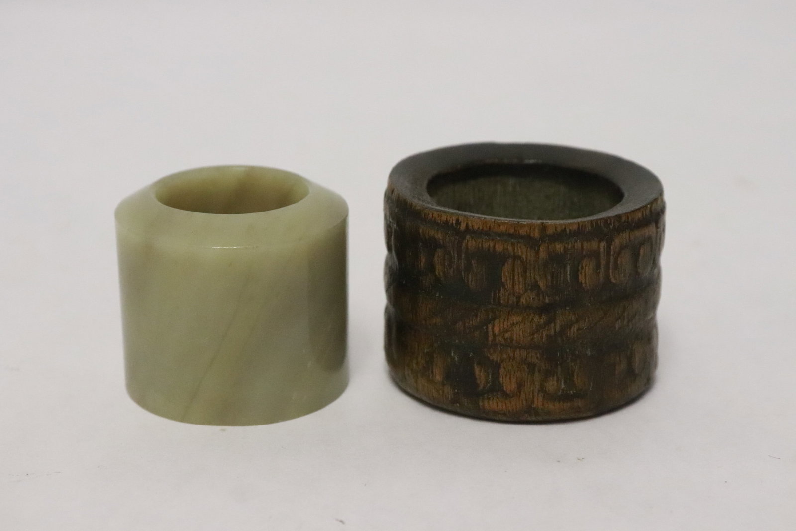2 archer's rings; one bamboo, one jade like stone: 2 archer's rings; one bamboo (1.18"x1.6"dia), one jade like stone (1.18"x1.3"dia)