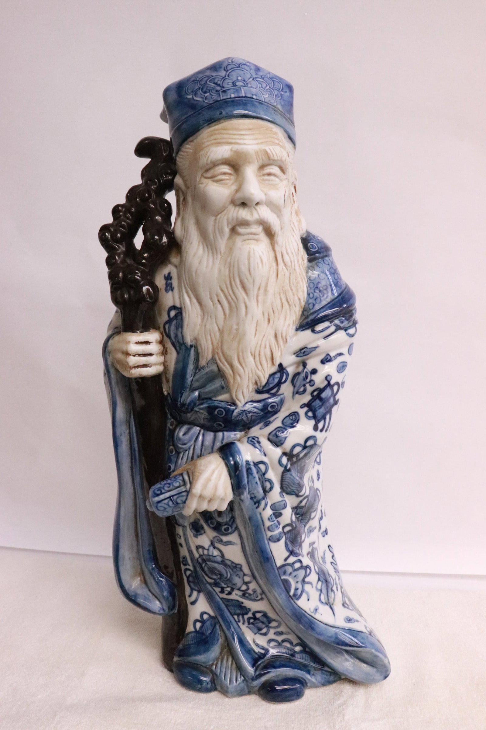 A vintage Chinese porcelain sculpture of deity: A vintage Chinese blue and white porcelain sculpture of deity, 18.5"H
