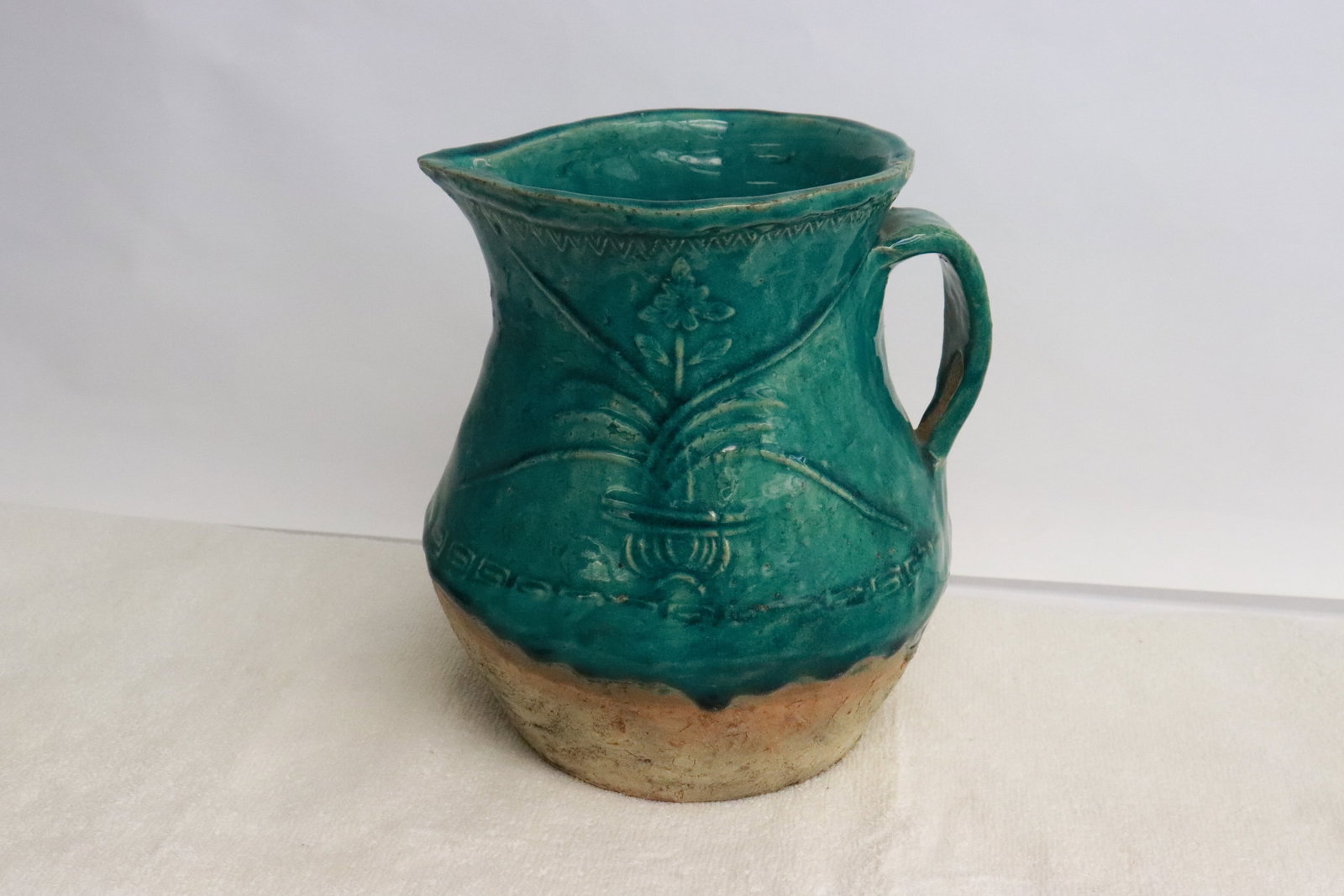 A Han style green glazed earthenware ewer: A Han style green glazed earthenware ewer, 7.8"x7.25"x7"