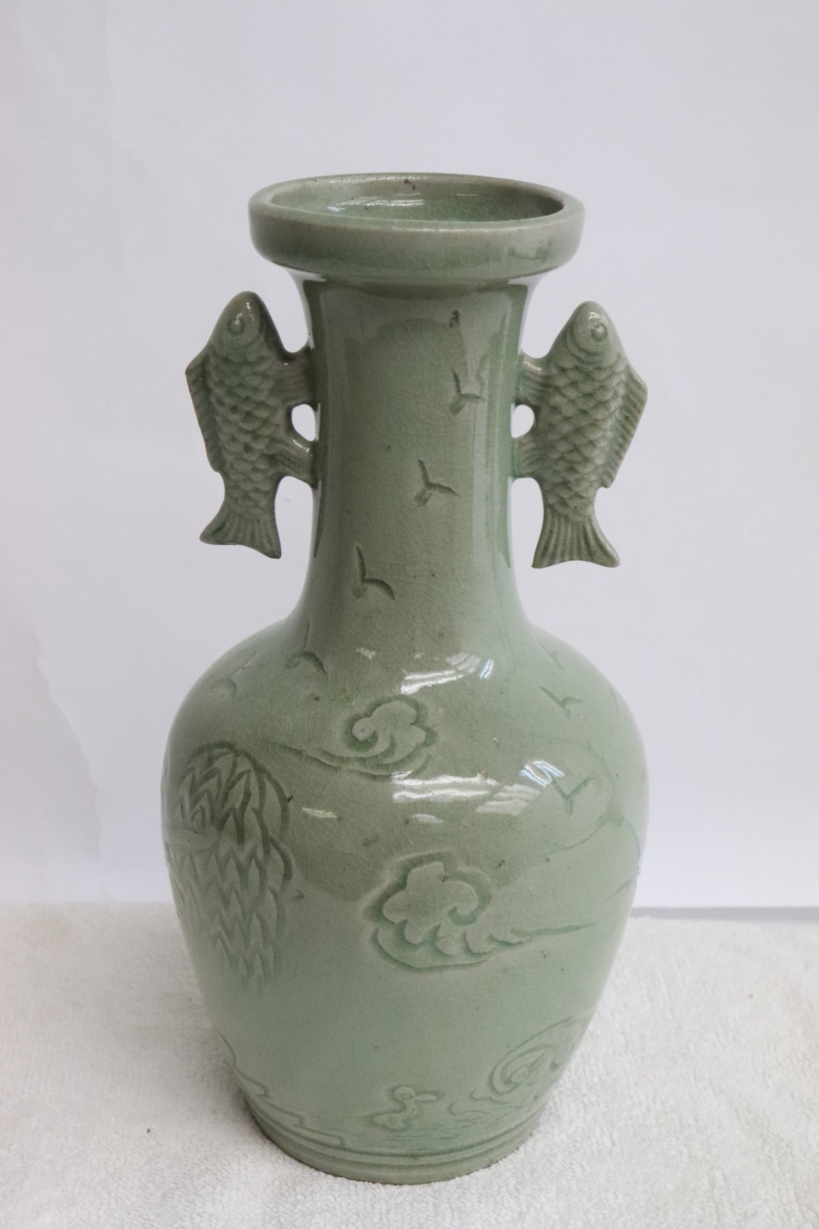 A celadon porcelain vase: A celadon porcelain vase, 8.95"x4.65"dia
