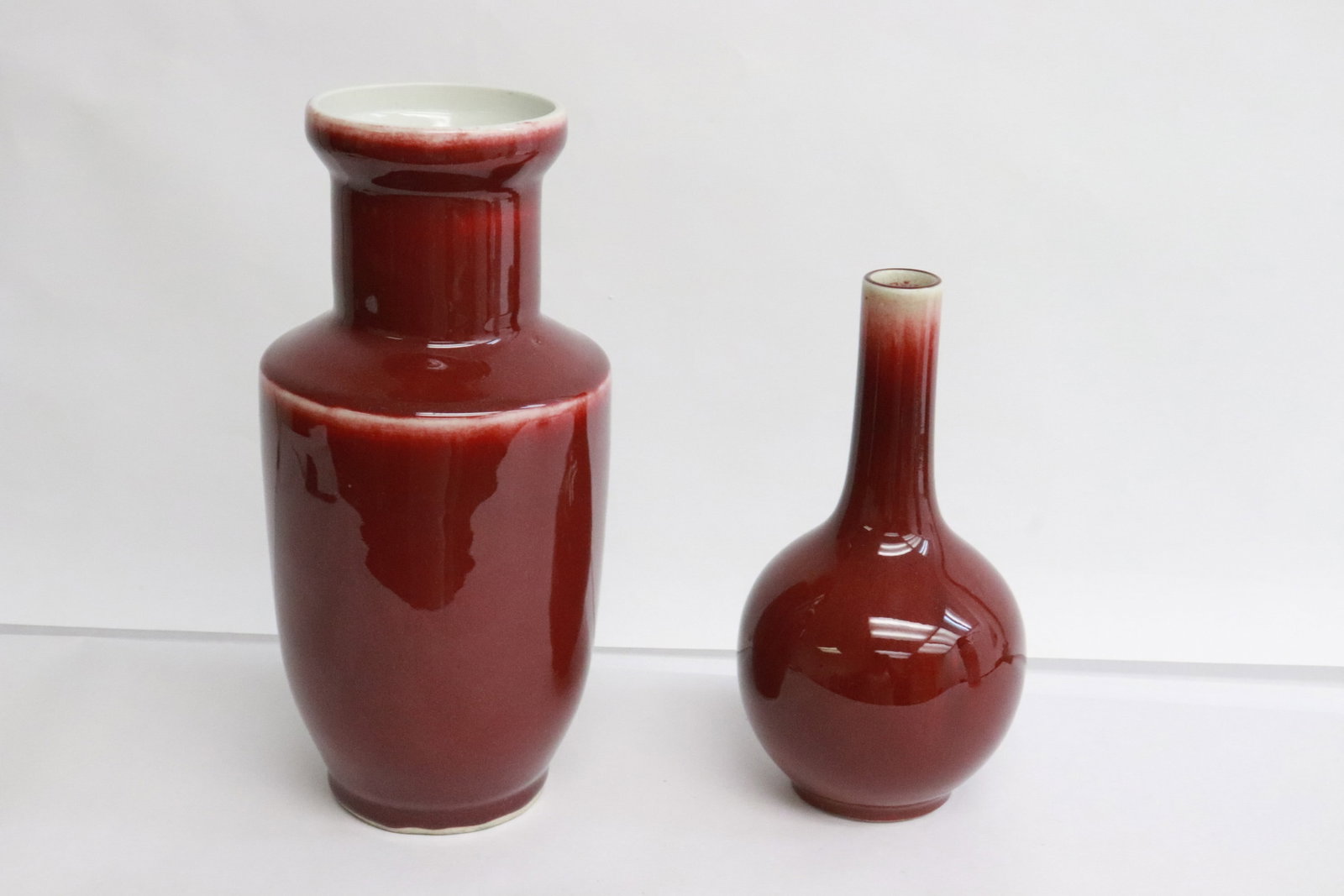 2 red glazed porcelain vases: 2 red glazed porcelain vases, 6.65"x3.65"dia, 8.5"x4.2"dia