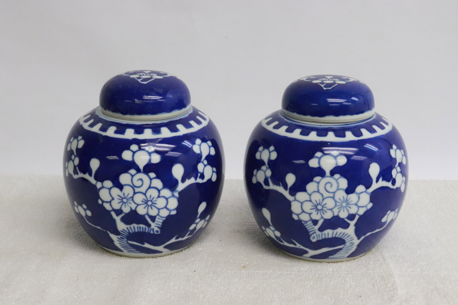 2 Chinese white on blue tea caddies: 2 Chinese white on blue tea caddies, 4.75"x4.4"dia ea