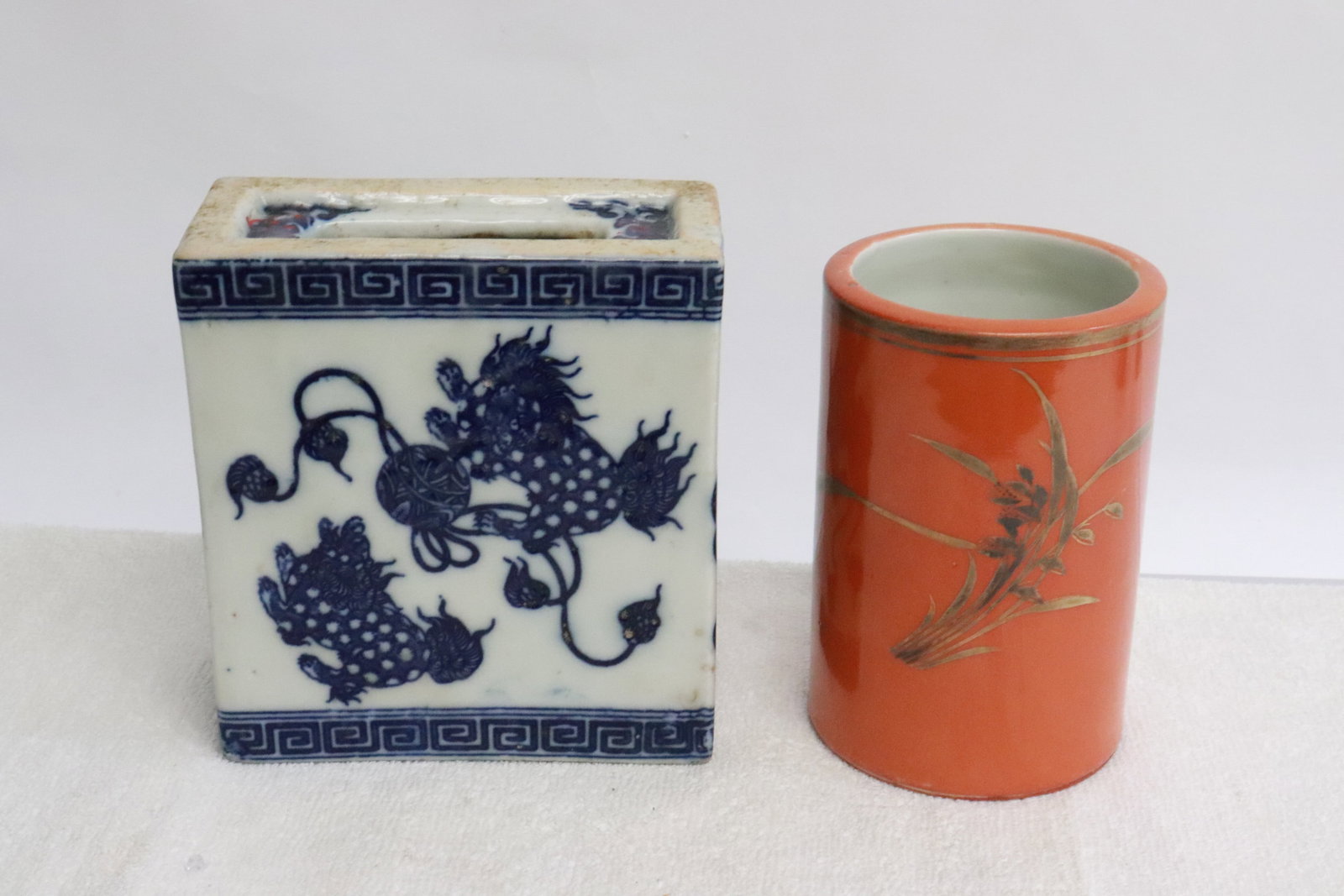 a blue and white censer, & a porcelain brush holder: 2 pieces; a blue and white censer (5.2"x4.75"x2.3"), and a gold on orange porcelain brush holder (4.8"x3.1"dia)