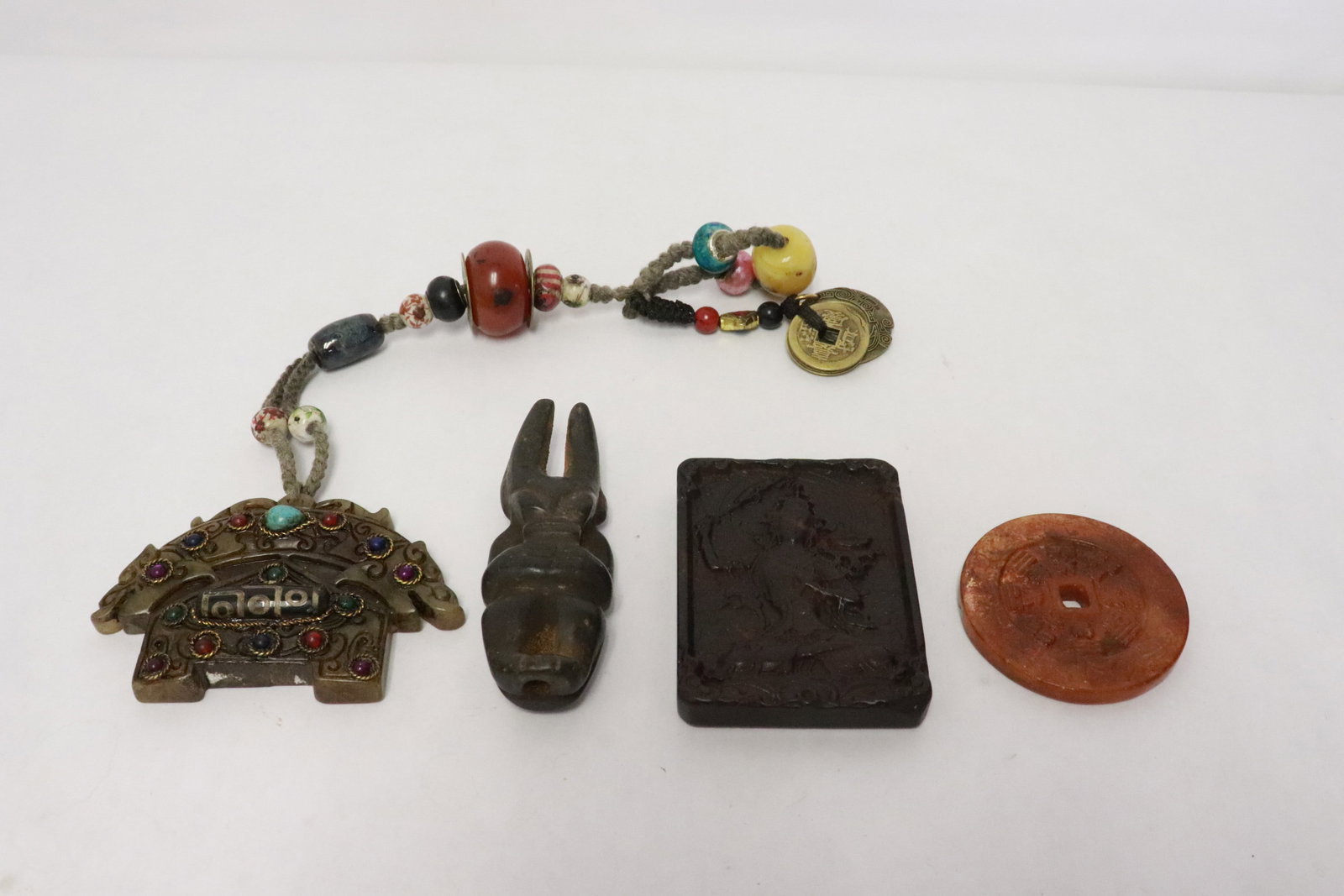 4 stone like carvings: 4 stone like carvings, 0.25"x2.15"dia - 2.5"x3.4"x0.65"