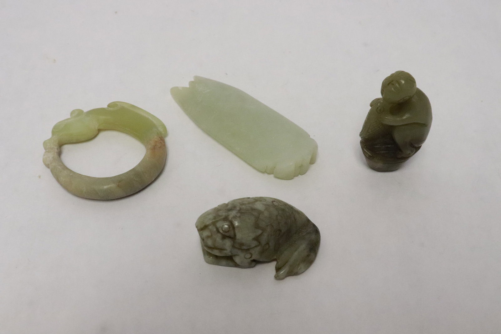 4 jade like stone carvings: 4 jade like stone carvings, 1.9"x1.25"x0.9" - 3.1"x1.18"x0.4"