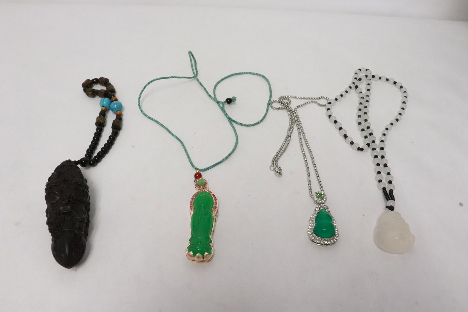 4 ornaments attached to necklace/ bracelet: 4 ornaments (1.33"x1.1"x0.65" - 3.6"x1.2"x1.2") attached to necklace/ bracelet
