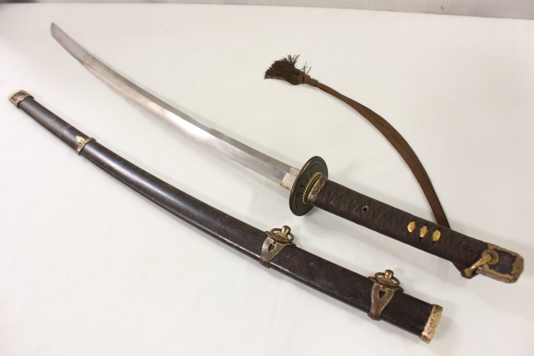 A fine Japanese samurai Katana sword: A fine Japanese samurai Katana sword, the blade probably 17th or 18th century with maker's mark on both side of tang, with WWII army mount, the scabbard appear to be eel skin, with shark skin wrapped 
