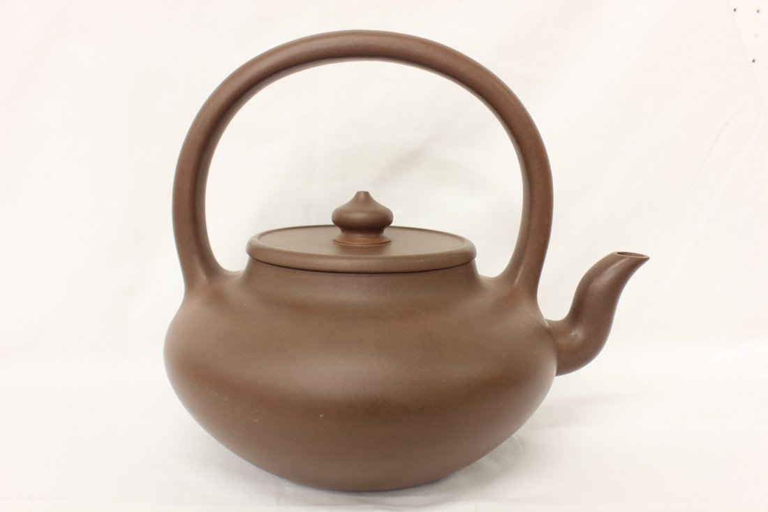 A large Chinese Yixing clay teapot: A large Chinese Yixing clay teapot, 9"Hx10.7"x8.3"
