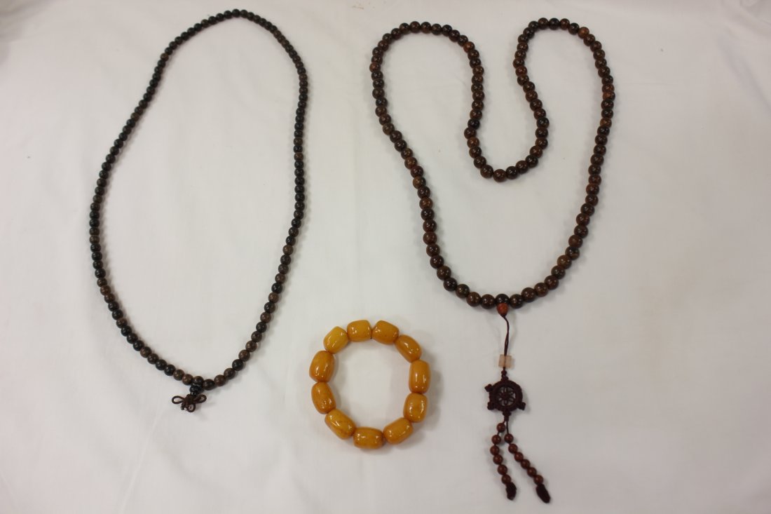 2 wood necklace and an amber bracelet: 2 wood necklace (109 beads each, 7.5mm & 10mm dia) and an amber bracelet (14mm-17mm in diameter x 11 beads)