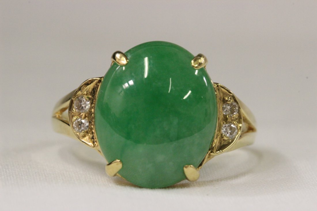 18K Y/G apple green jadeite diamond ring: 18K Y/G apple green jadeite ring, center jadeite measures 13mmx11.2mmx4.5mm, accented by 4 small diamonds, wt. 3.5gm, size 6.5