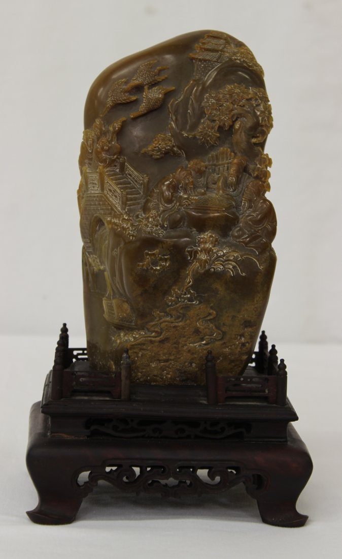 A fine soapstone carved boulder: A fine soapstone carved boulder (7.95"Hx4.6"x3") decorated with landscape in relief