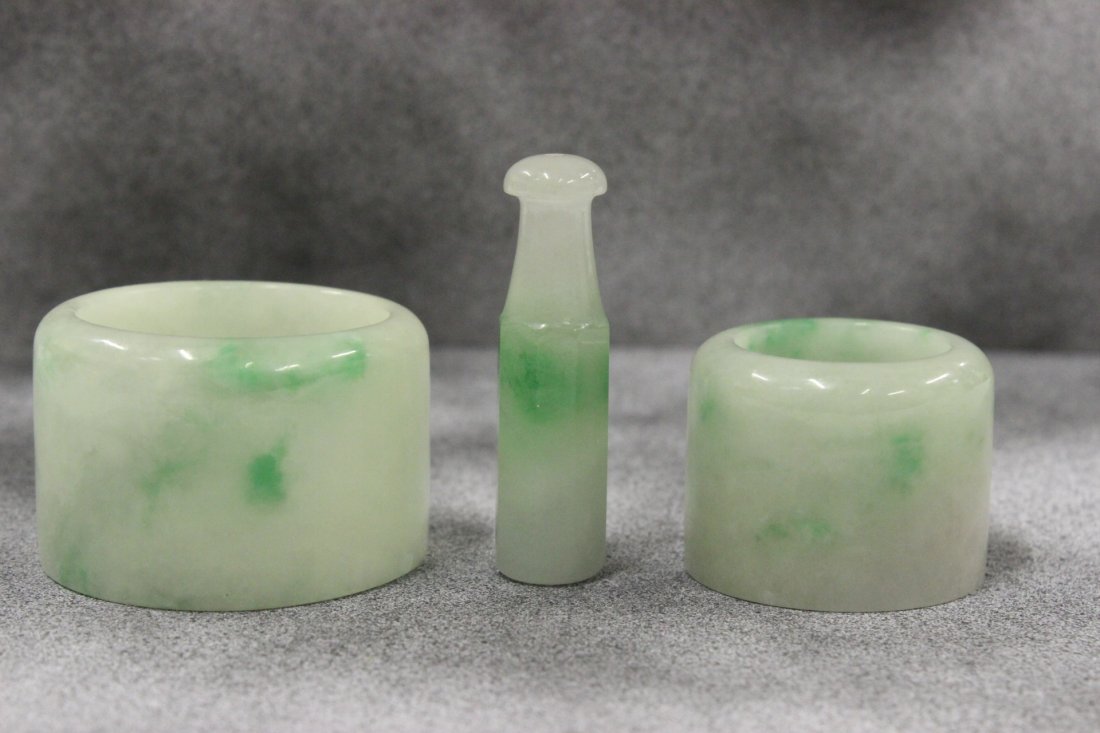 2 jadeite archer's ring and a jadeite cigarette holder: 2 jadeite archer's ring (1.1"Dx1.7"od, 1"Dx1.3"od) and a jadeite cigarette holder (1.8"Lx0.5"dia)