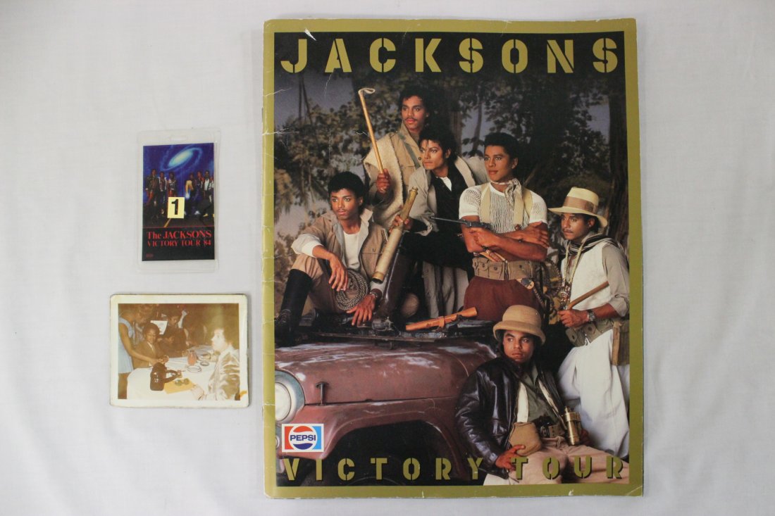 signed Victory Tour book, security pass, & a photo: A rare Victory Tour book (14"x11.1"), signed by Michael Jackson, Jermaine Jackson, Jackie Jackson, Tito Marlon Jackson, and Randy Jackson, together with #1 security pass of the tour (3.45"x2.2"), and 