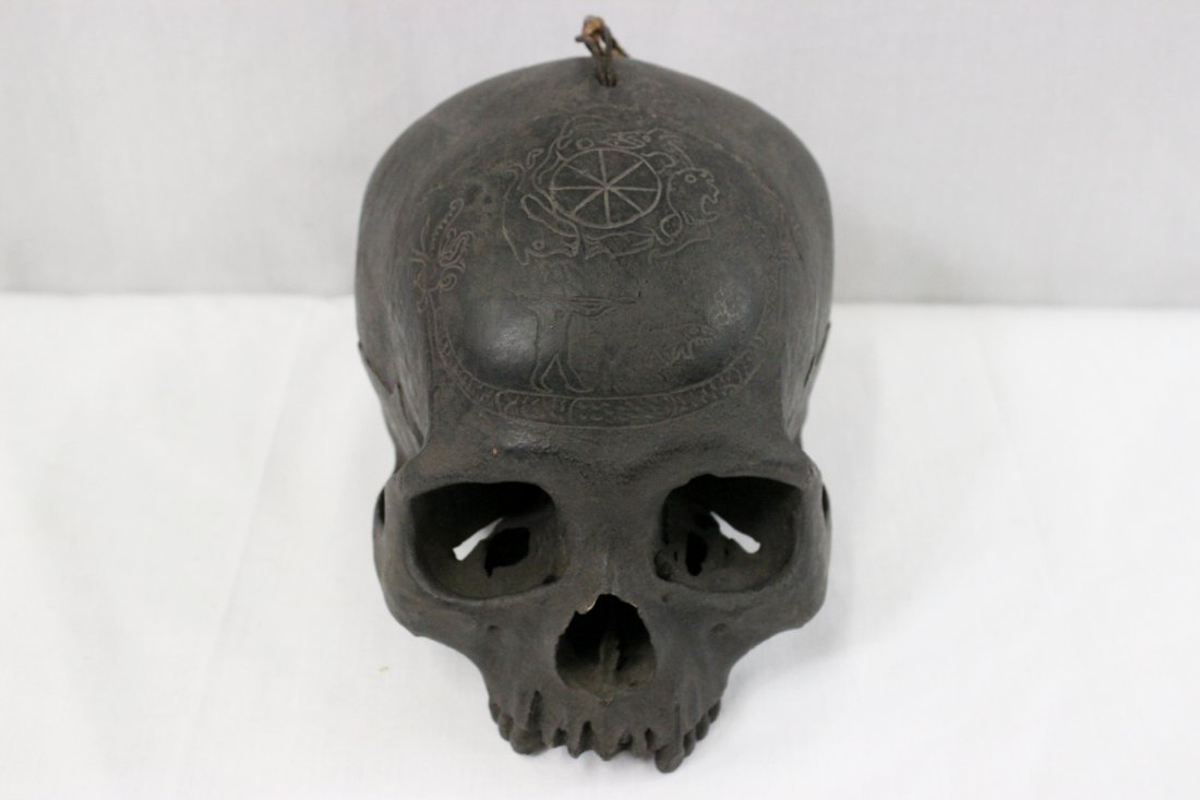 A rare antique head hunter's human skull trophy: A rare and important antique head hunter's human skull trophy (5.5"x7.6"x5.5") with engraving on top to depict hunting/ritual scene (Bahau tribe, Iban skull from Sarawak). Origin: Long Pahangai, upper