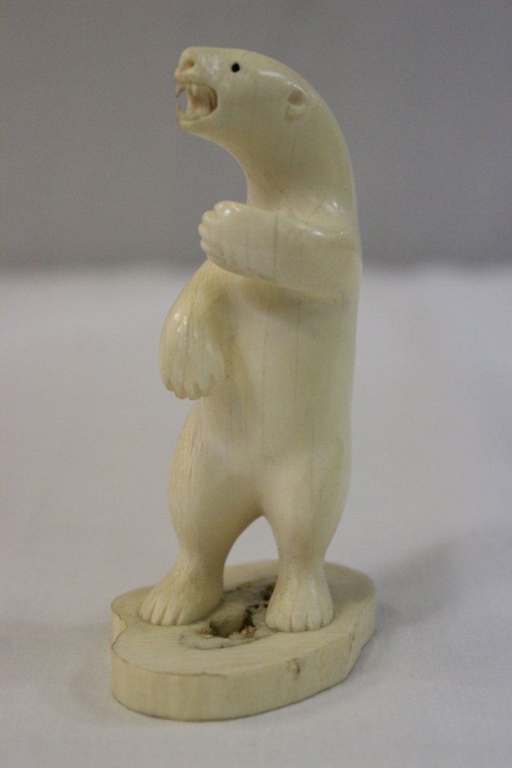 A walrus ivory carved polar bear: A walrus ivory carved polar bear, 4.25"Hx2.7"x1.9"