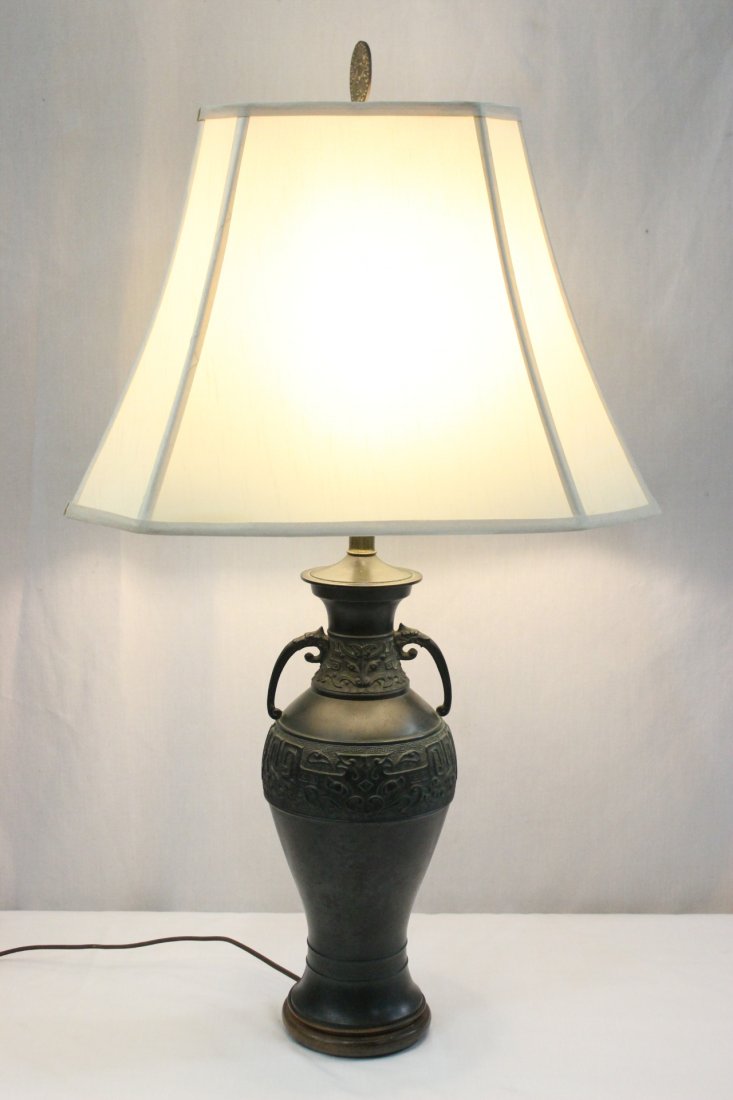 A Chinese/Japanese bronze vase, made as lamp: A Chinese/Japanese bronze vase (15"H) with tao tai mask motif in relief and qilin motif handle, made as a lamp (bottom missing) (33.5"Hx19"x12.75")