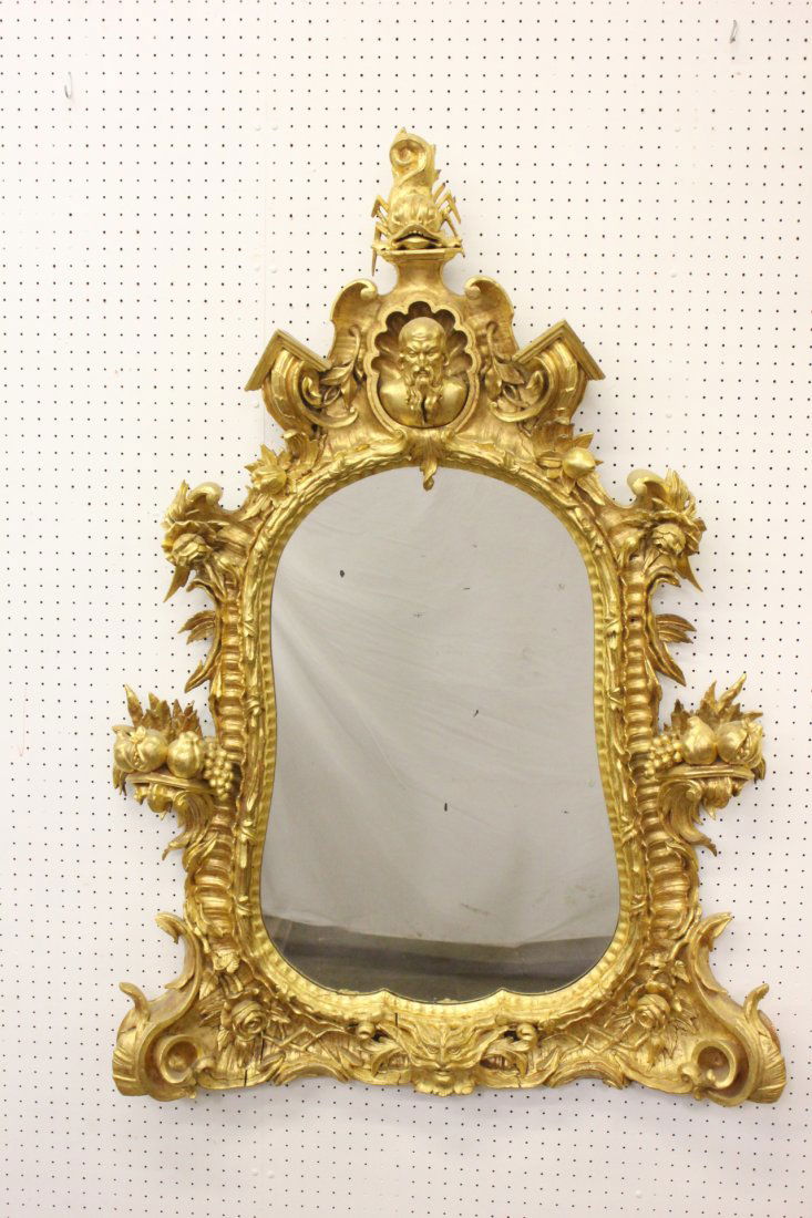 Magnificent French antique gilt wood wall mirror: A magnificent French antique gilt wood wall mirror carved with figural, animal and fruit motif, 57"Hx40"x5.5"