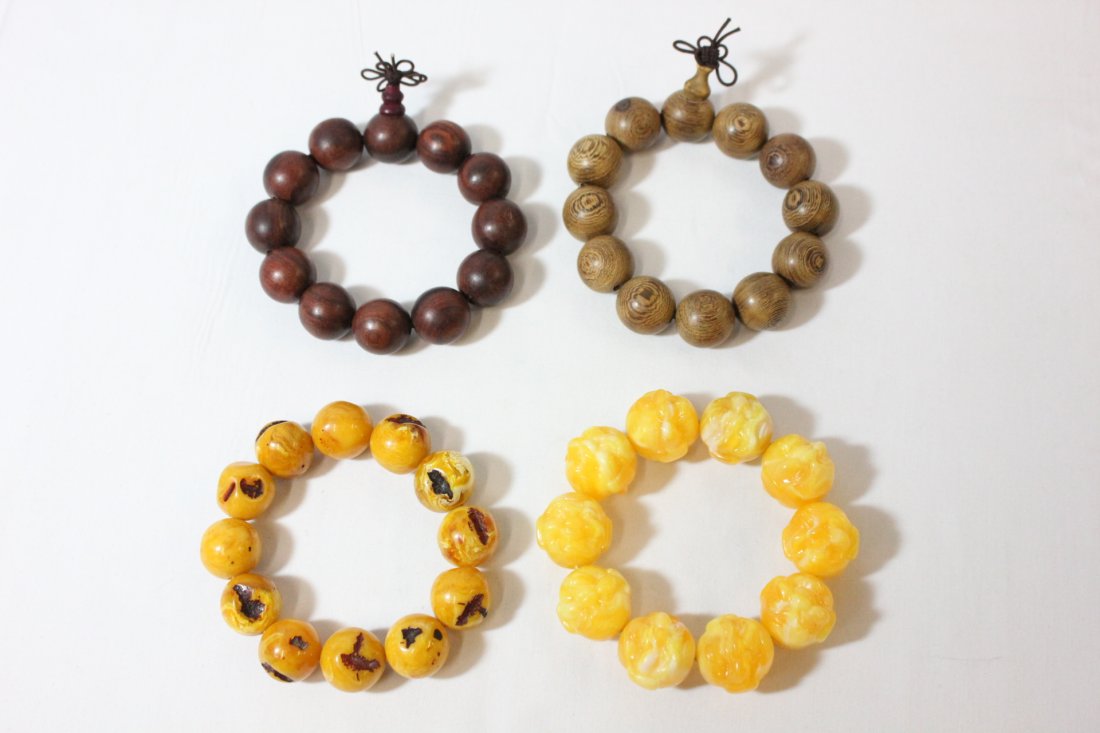 2 wood bead bracelets and 2 amber like bead bracelets: 2 wood bead bracelets (0.7"diax12 beads, 0.75"dia x12 beads) and 2 amber like bead bracelets (0.75"dia x12 beads, 0.95"dia x 10 beads)