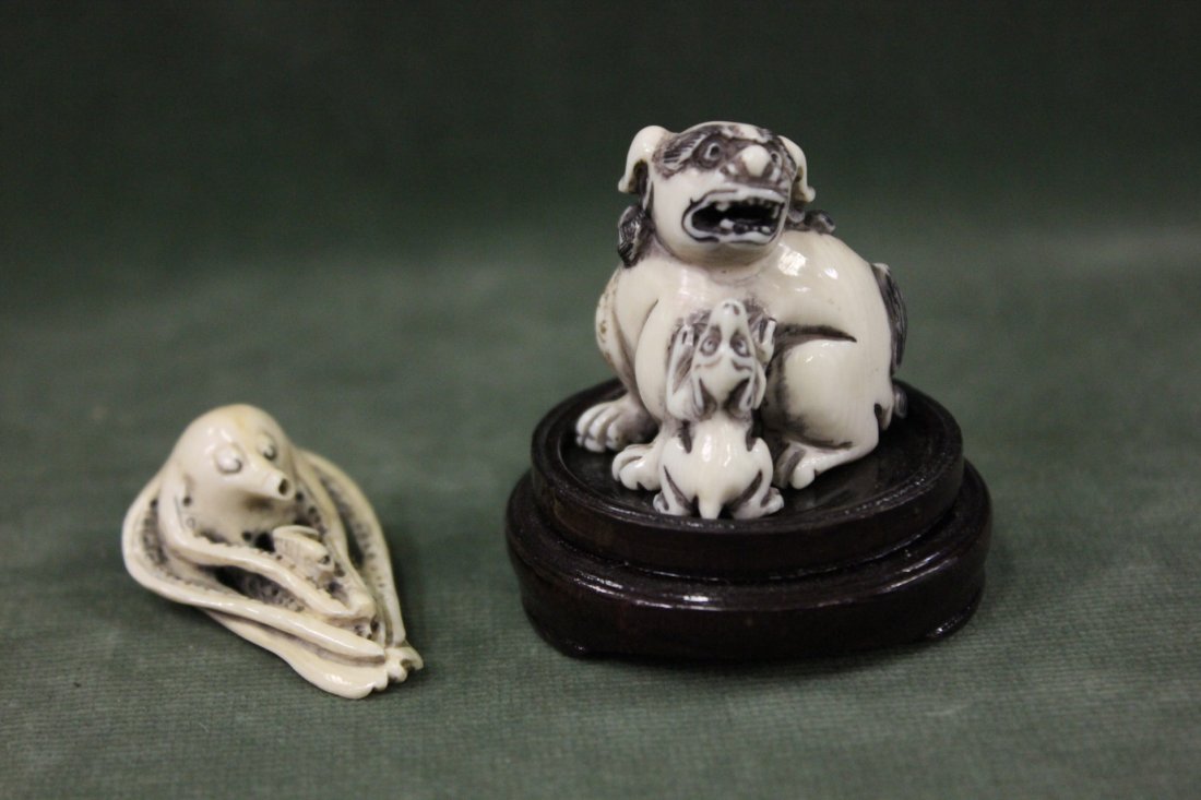 2 Japanese ivory carved netsuke: 2 Japanese ivory carved netsuke; octopus (1.6"L) and lion with dog (1.5"H)