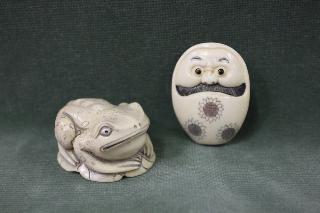 2 Japanese ivory carved netsuke: 2 Japanese ivory carved netsuke; a frog (1.6"x1.3"x0.8") and a doll with moving eye (1.55"x1.2"x0.7")