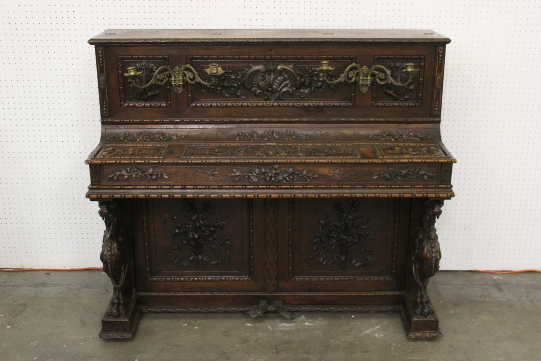 A beautiful French 18th/19th century piano: A beautiful French 18th/19th century piano decorated with elaborate carving depicting gargoyle and family crest, 46.5"Hx54.5"x23"