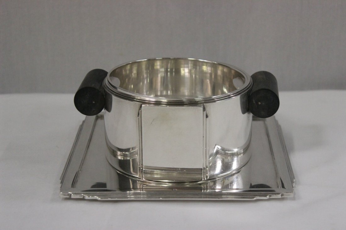 French Art Deco silver cup, by Jean E. Puiforcat: An important early art deco French silver center cup (2.5"Hx6"x4.75") with under plate (0.35"Hx6.8"x6.8"), the under plate and the cup signed with Jean E. Puiforcat with the stamp and French hallmark,