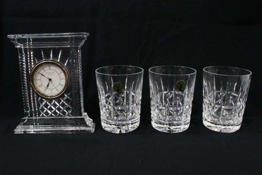 4 Waterford crystals: A Waterford crystal table clock (7"Hx5.8"x1.65") and 3 Waterford water crystals (4.4"Hx3.4"dia each)