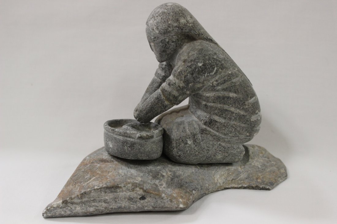 Inuit stone carving by Charlie Sivuarapik: Inuit stone carving depicting woman working by Charlie Sivuarapik, 4.9"Hx7.2"x4.2"