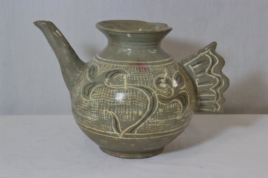 Antique Korean celadon pottery wine pot: Antique Korean celadon pottery wine pot (7"Hx10.25"x6.5") painted with flowers, the handle in feather motif (the sprout tip has minor chip)