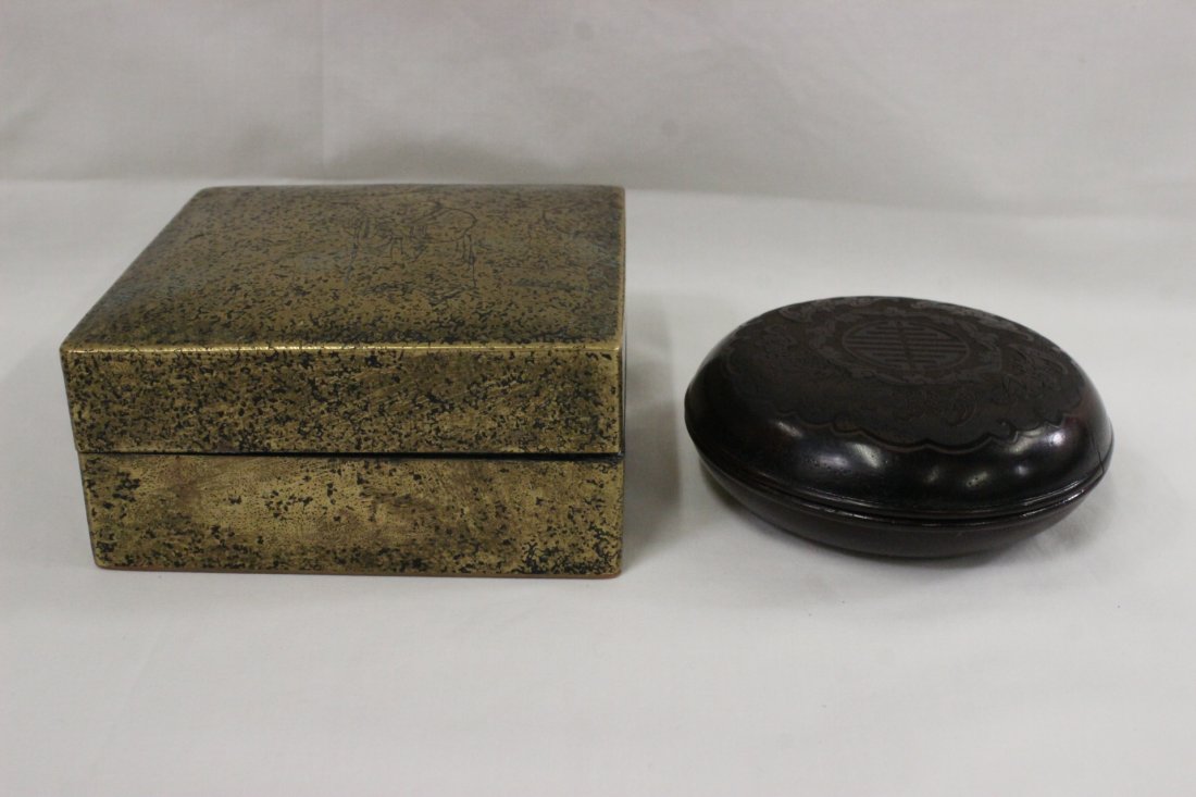 A bronze ink box, and a wood(?) ink box: A bronze ink box (2"Hx3.95"x3.95") engraved with scholar scene, and a wood(?) ink box (1.4"Hx3.4"dia) with longevity symbol