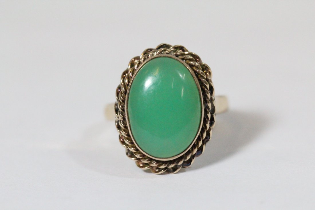 18K Y/G jadeite ring: 18K Y/G ring, center an apple green jadeite measures 14x10x3.3mm, wt. 4.4gm, size 5.5