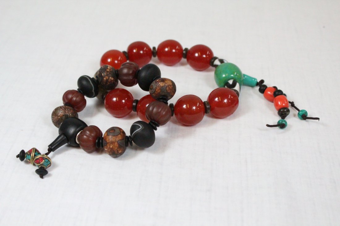 2 Chinese bead bracelets: Chinese amber style bead bracelet 8.8"Lx1"dia., and Chinese dzi bead bracelet (5"Lx1"dia.)