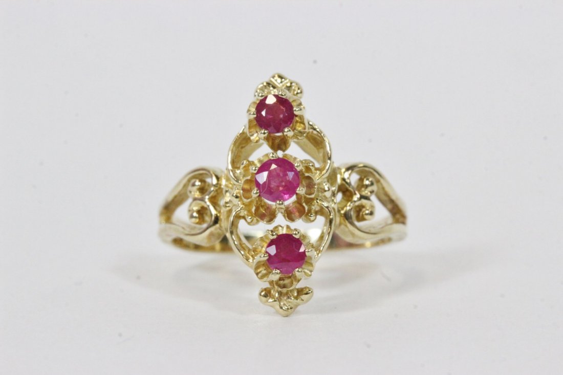 10K Y/G ring, set with 3 rubies: 10K Y/G ring, set with 3 rubies, wt. 3.7gm, size 7