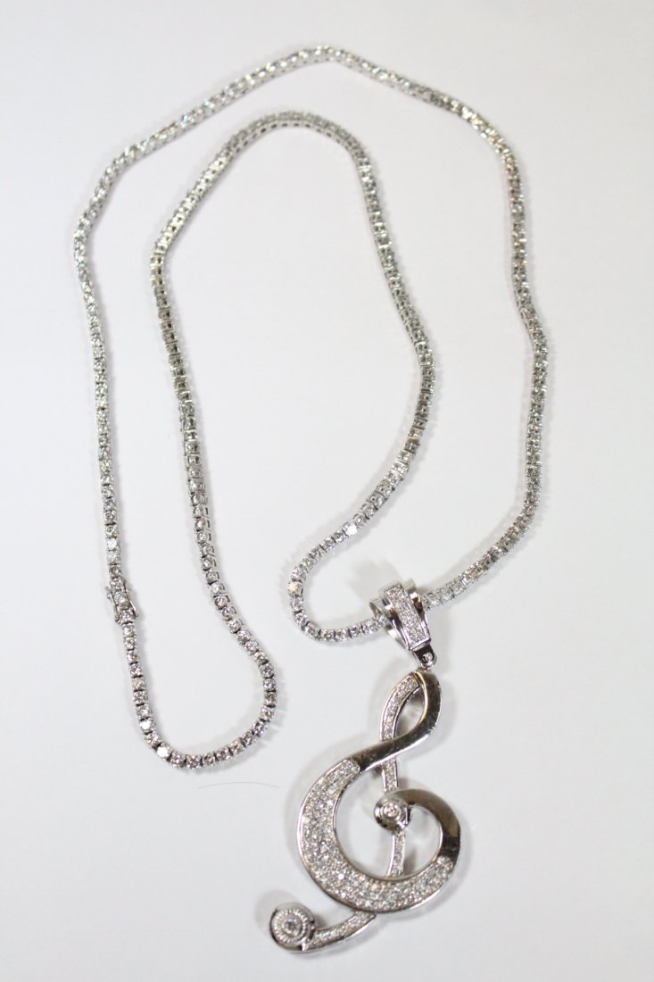 silver pendant attached to a long silver necklace (1 of 10)
